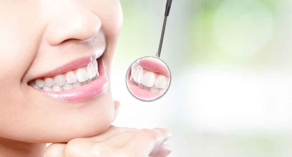 Healthy woman teeth and dentist mouth mirror