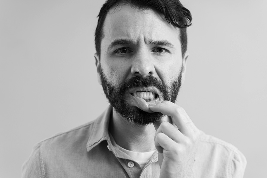 A guy showing his gum disease